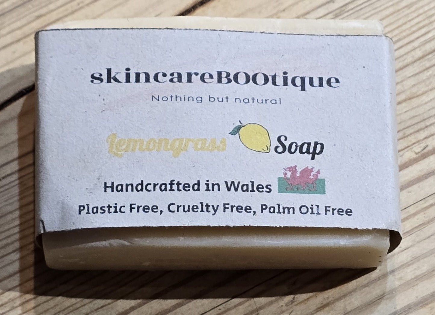 Bar of natural Lemongrass soap with 'skincareBOOtique' packaging on a wooden surface