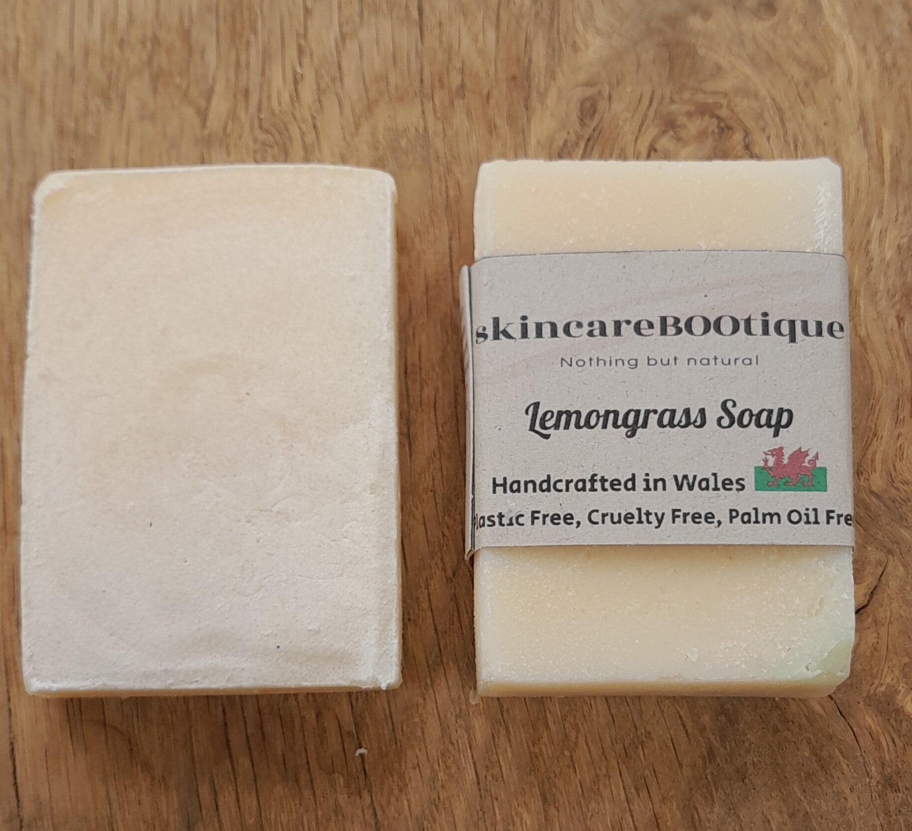 Two bars of skincareBOOtique lemongrass soap with packaging that reads 'Lemongrass Soap', stating the product is handcrafted in Wales, plastic free, cruelty free, and palm oil free.